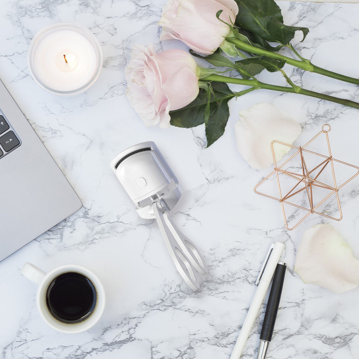 GlowCurl heated eyelash curler on a marble vanity